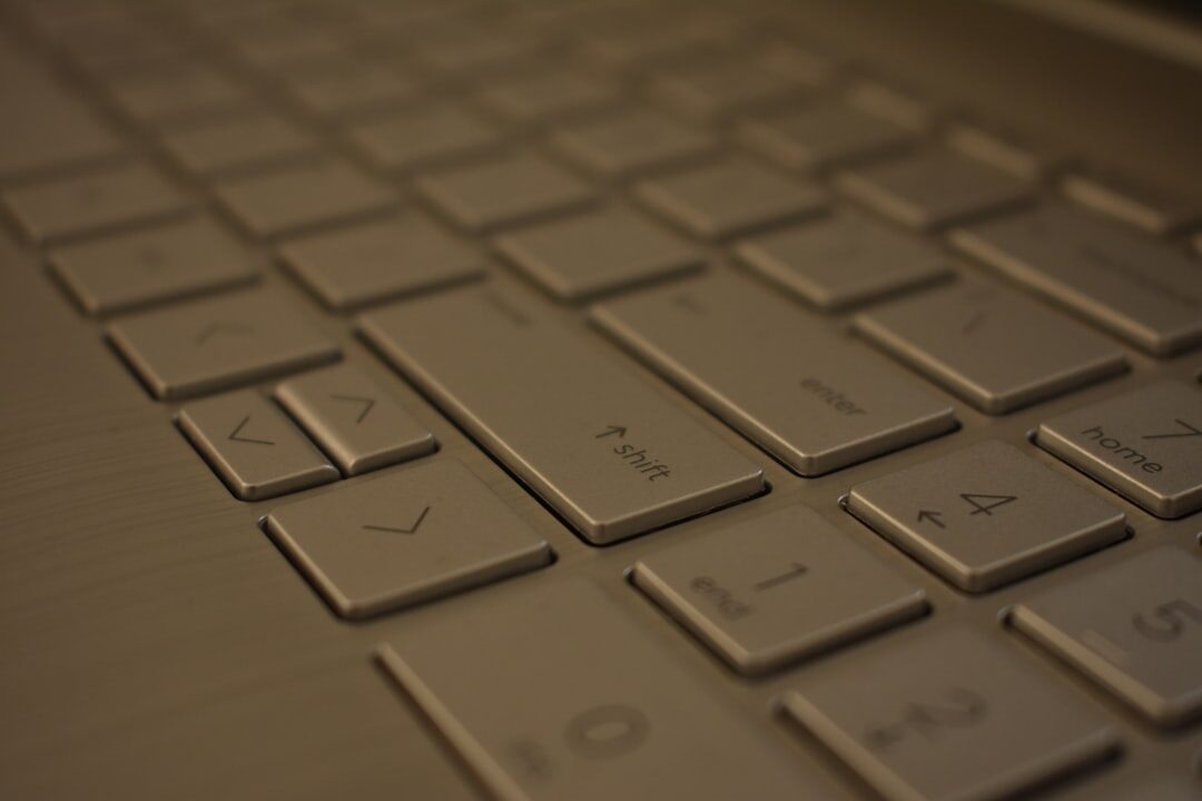 Close-up of hands typing on a laptop keyboard